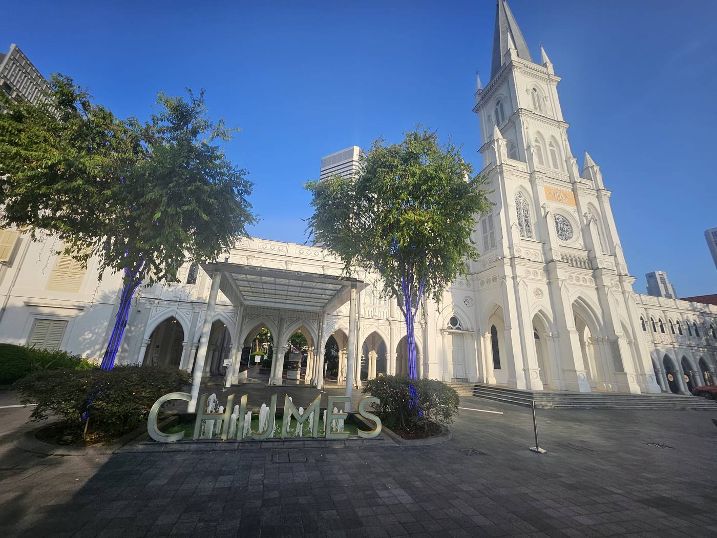 CHIJMES fountain court and chapel spire in morning light, Singapore