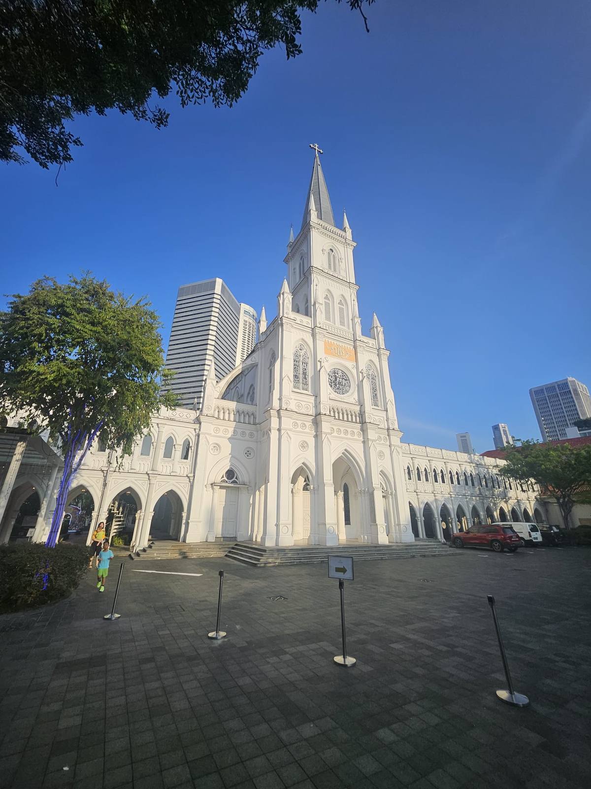 CHIJMES Hall โ the former convent chapel of 1841 โ glowing white against the CBD skyline