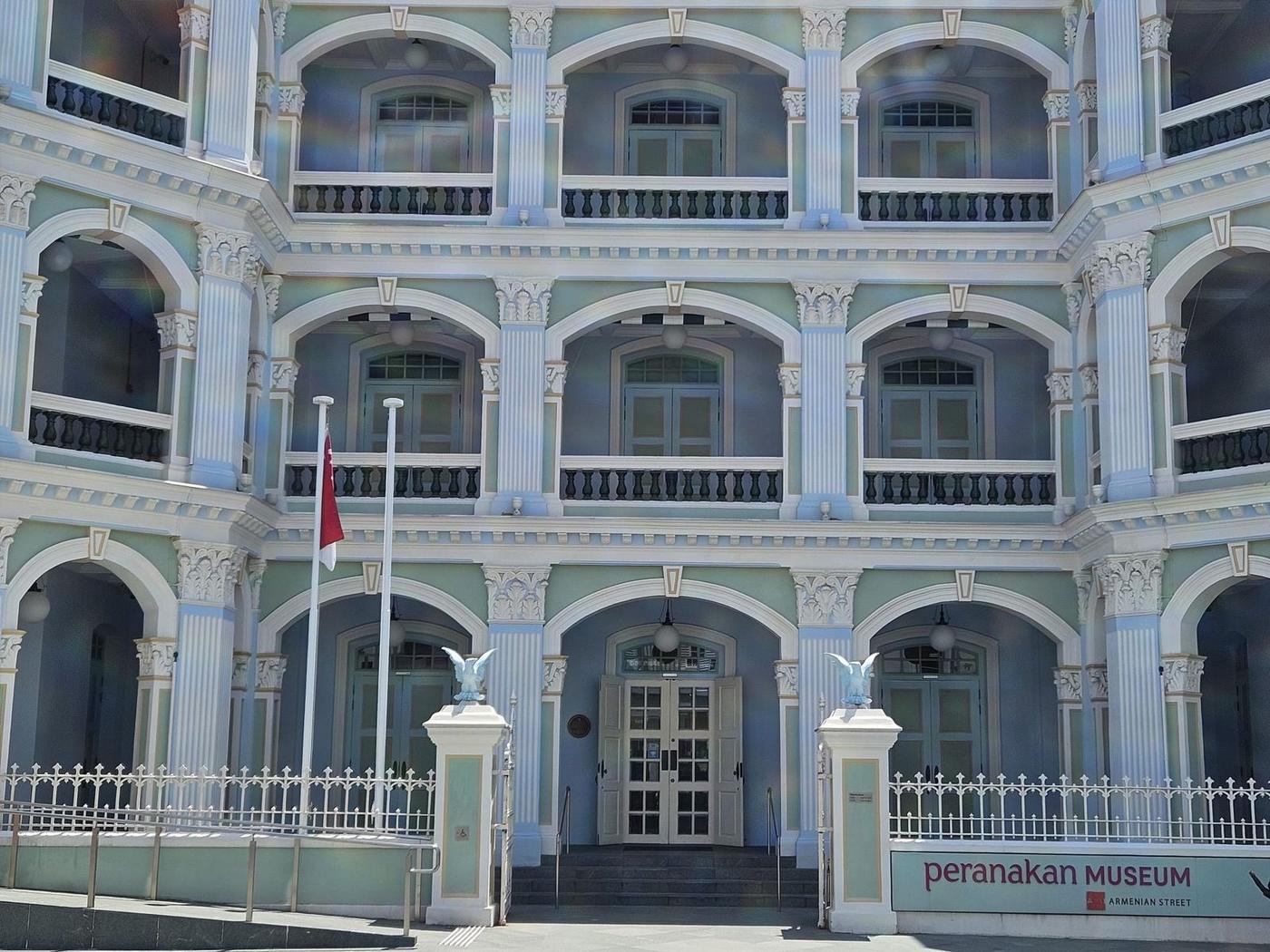Mint-green arches and columns of the Peranakan Museum facade in detail