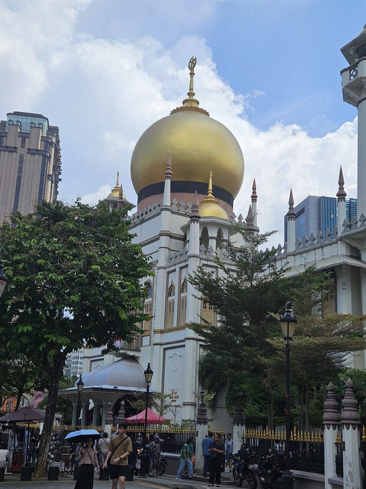 The golden dome of Sultan Mosque in Kampong Glam against the city skyline